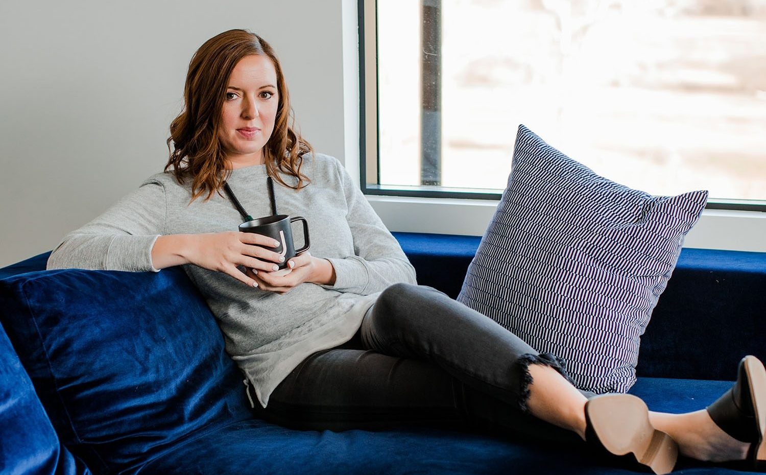 Woman Drinks Coffee In Front of Window