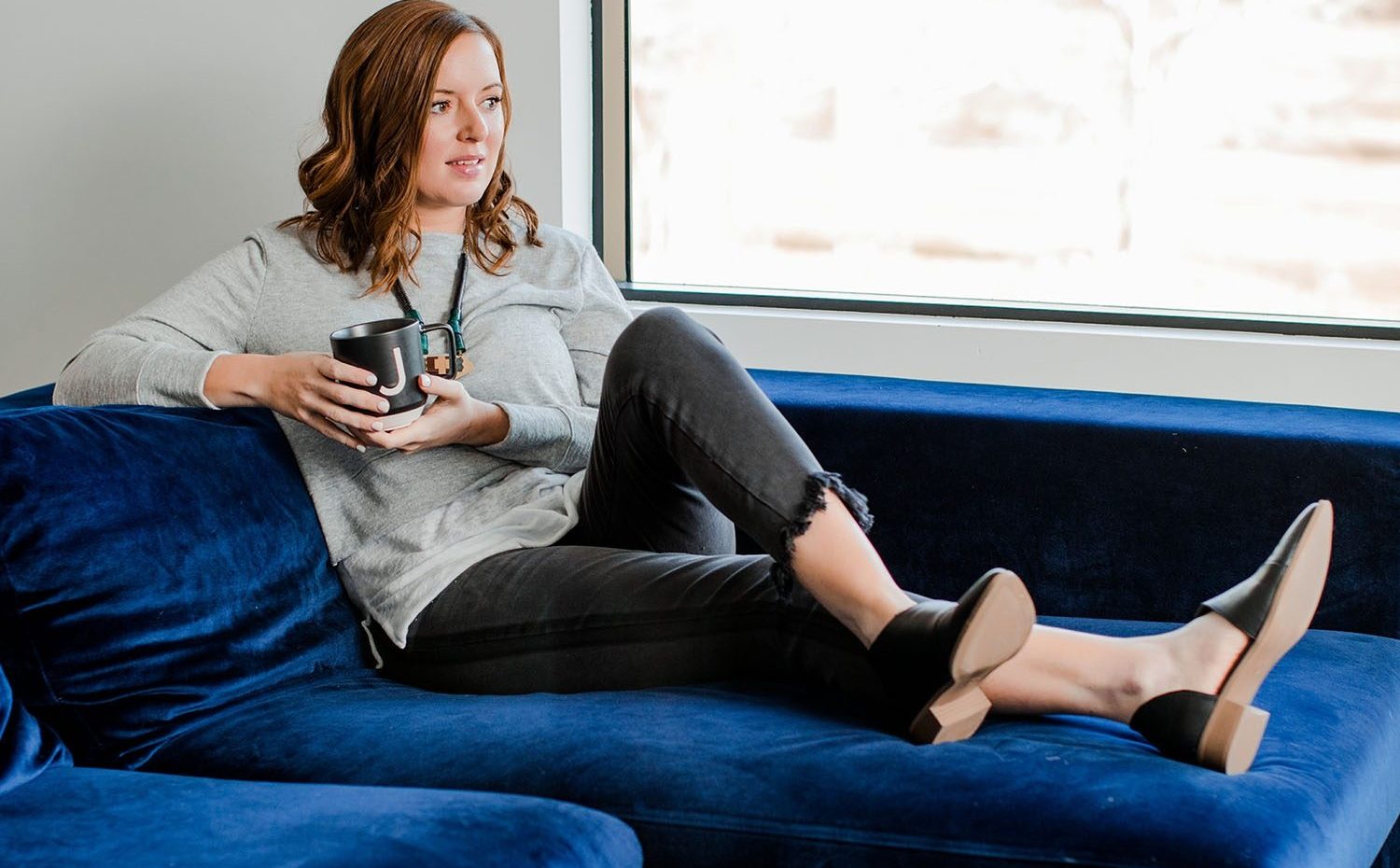 Frock Boutique Model on Velvet Sofa Models Black Pants & Leather Shoes