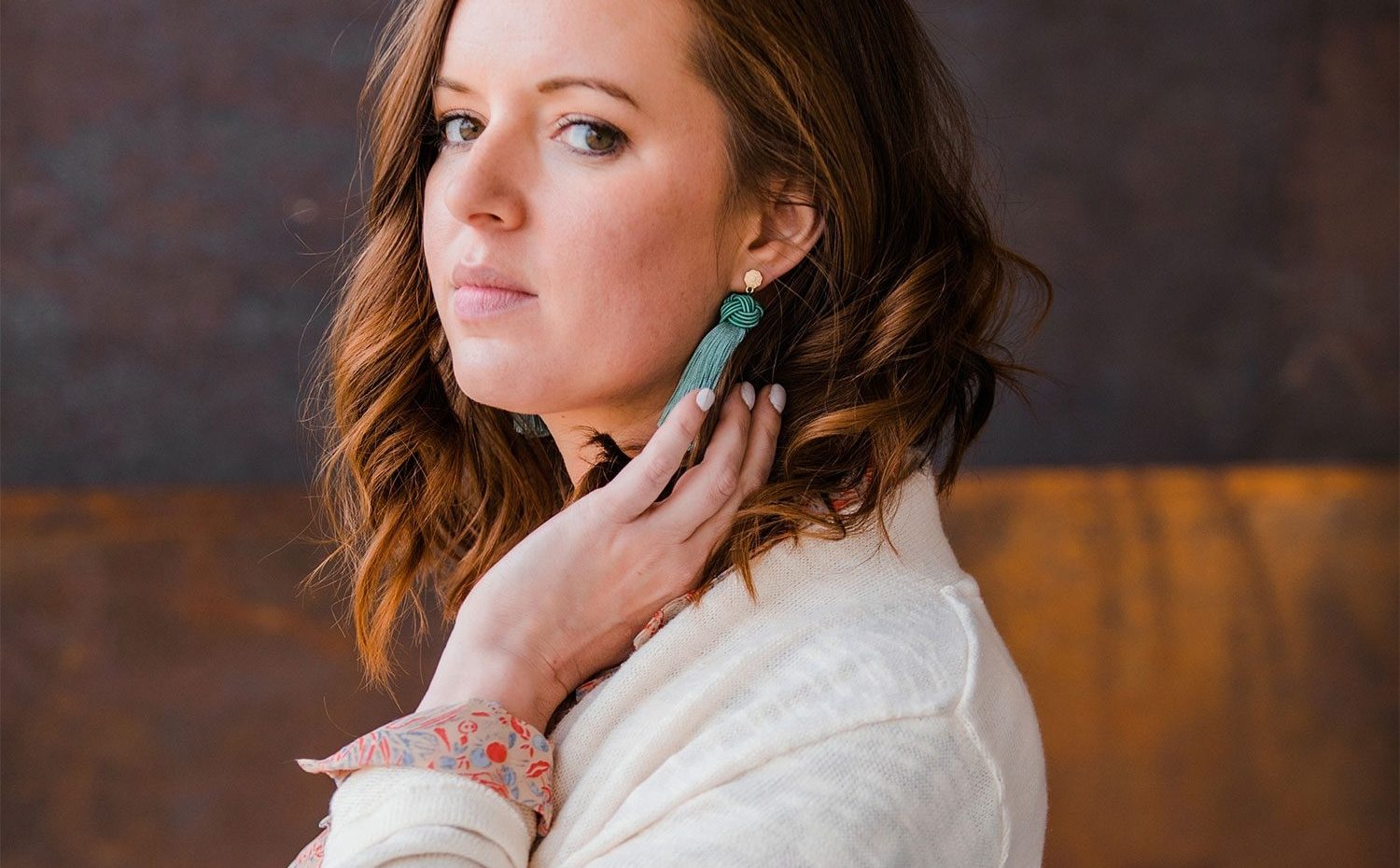 Woman Models White Cardigan With Green Earrings For Frock Boutique