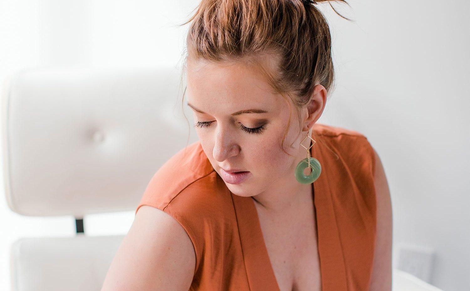 Woman Wearing An Orange Jumpsuit Modelling For Frock Boutique Asheville NC